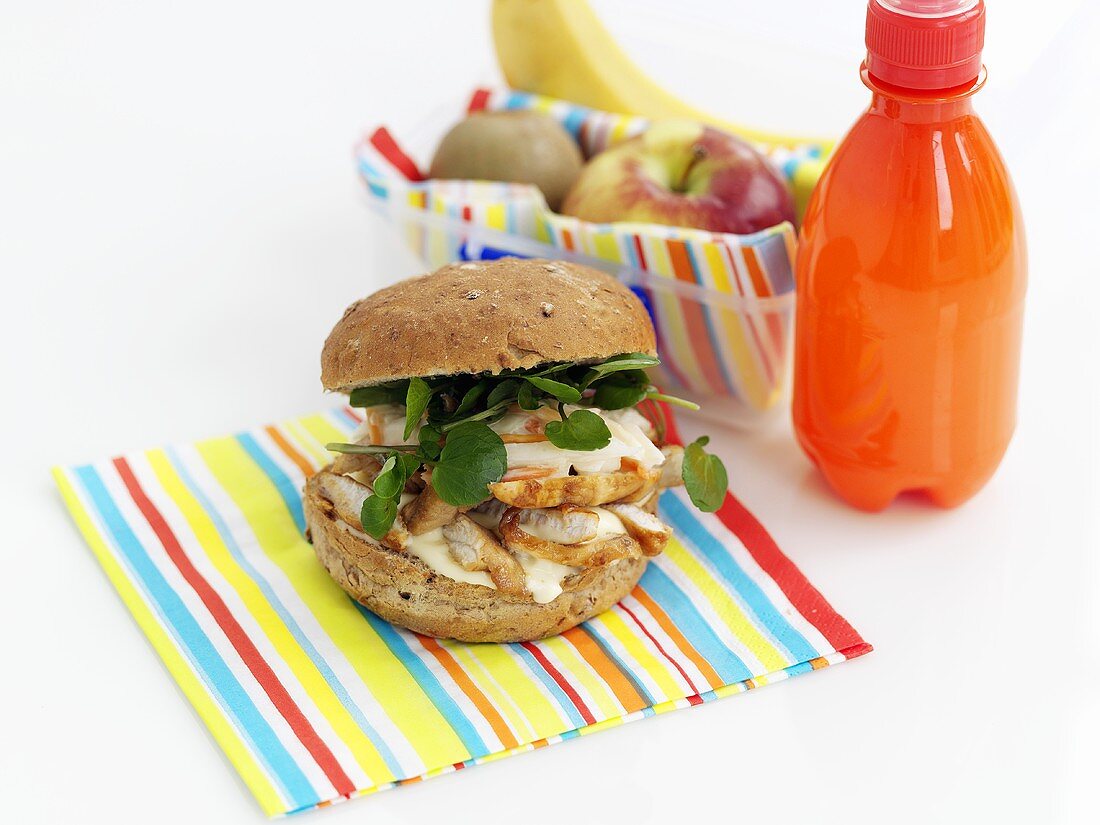 Hähnchenburger, Obst und Getränk zum Lunch