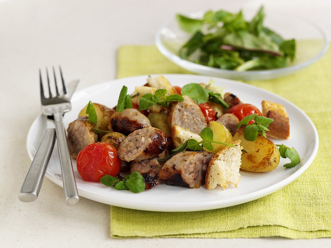 Fried sausage with potatoes and cherry tomatoes