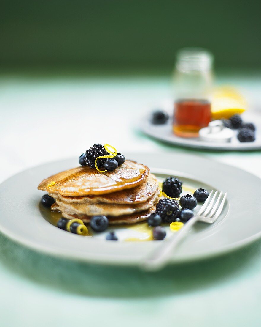 Pancakes with blueberries, blackberries and maple syrup