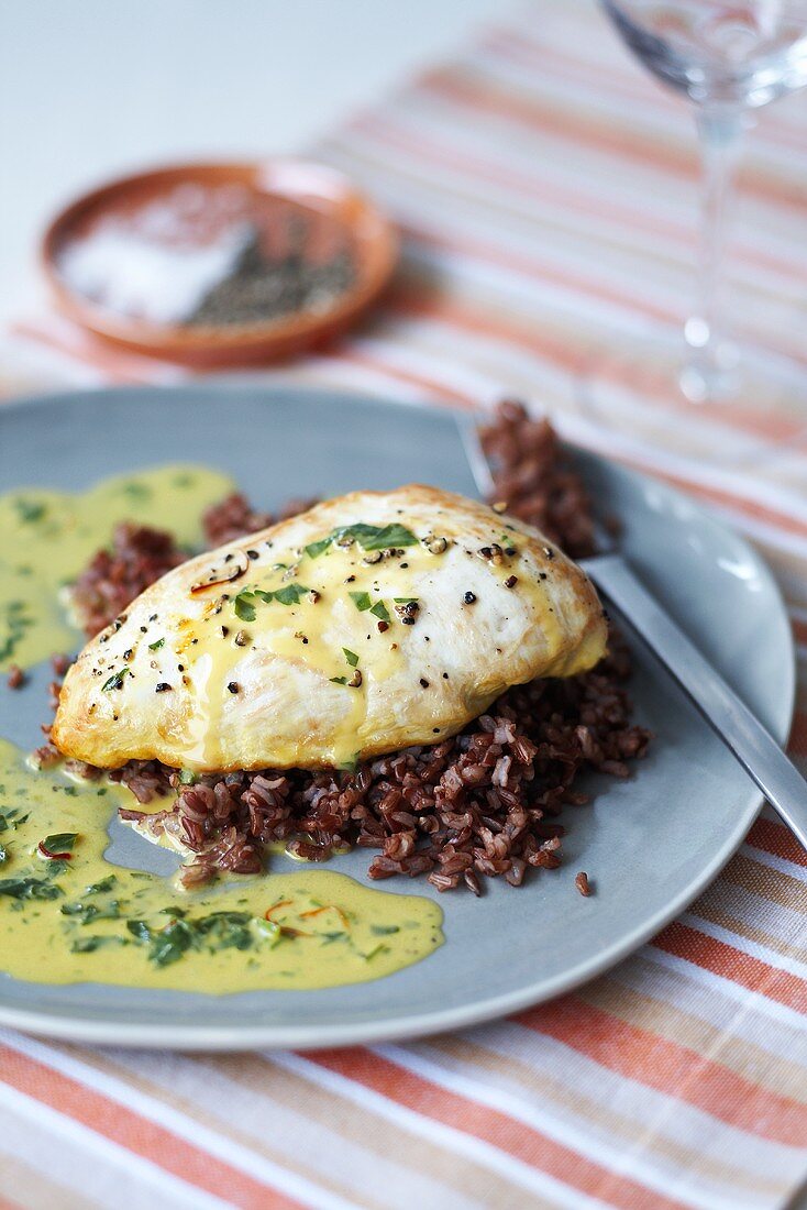 Chicken breast with saffron parsley sauce and red rice