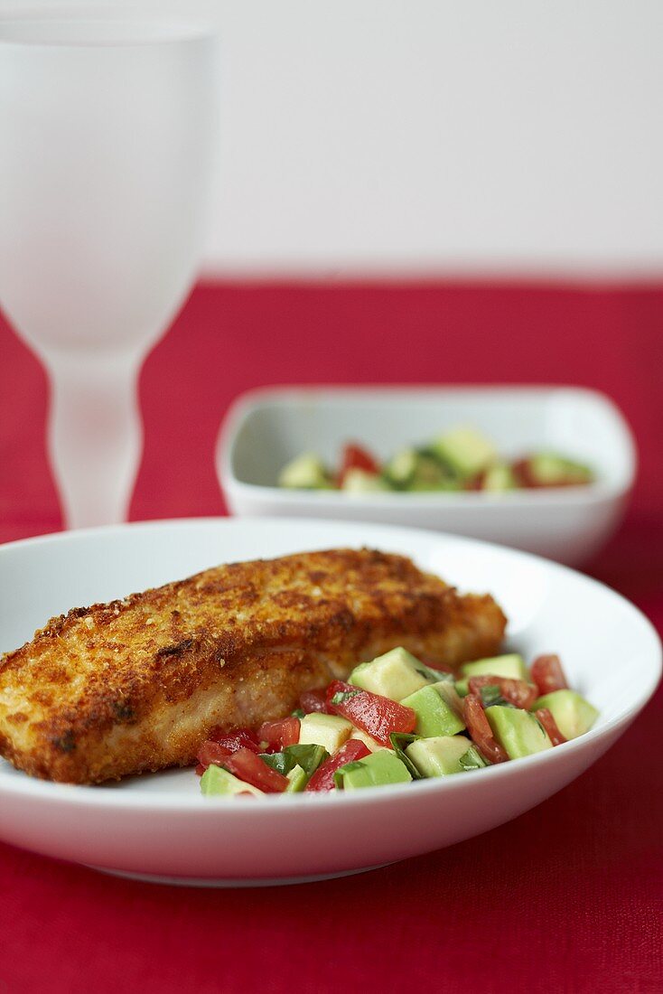 Breaded salmon with tomato and cucumber salad