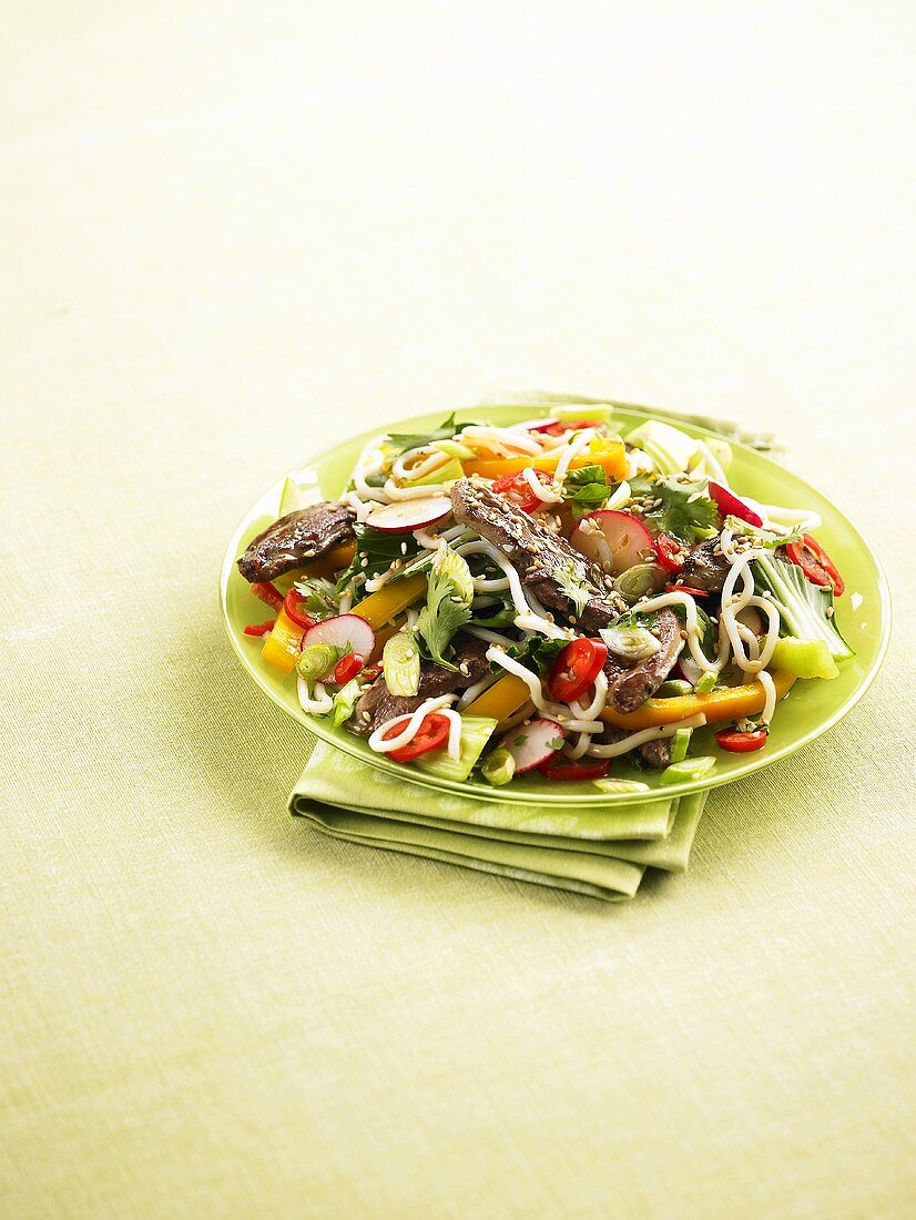 Vegetable salad with rice noodles and duck breast