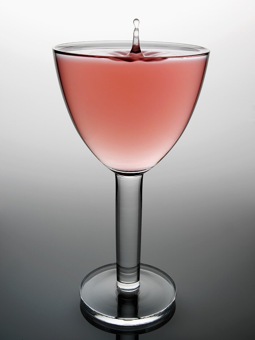 Glass of rosé wine with drop