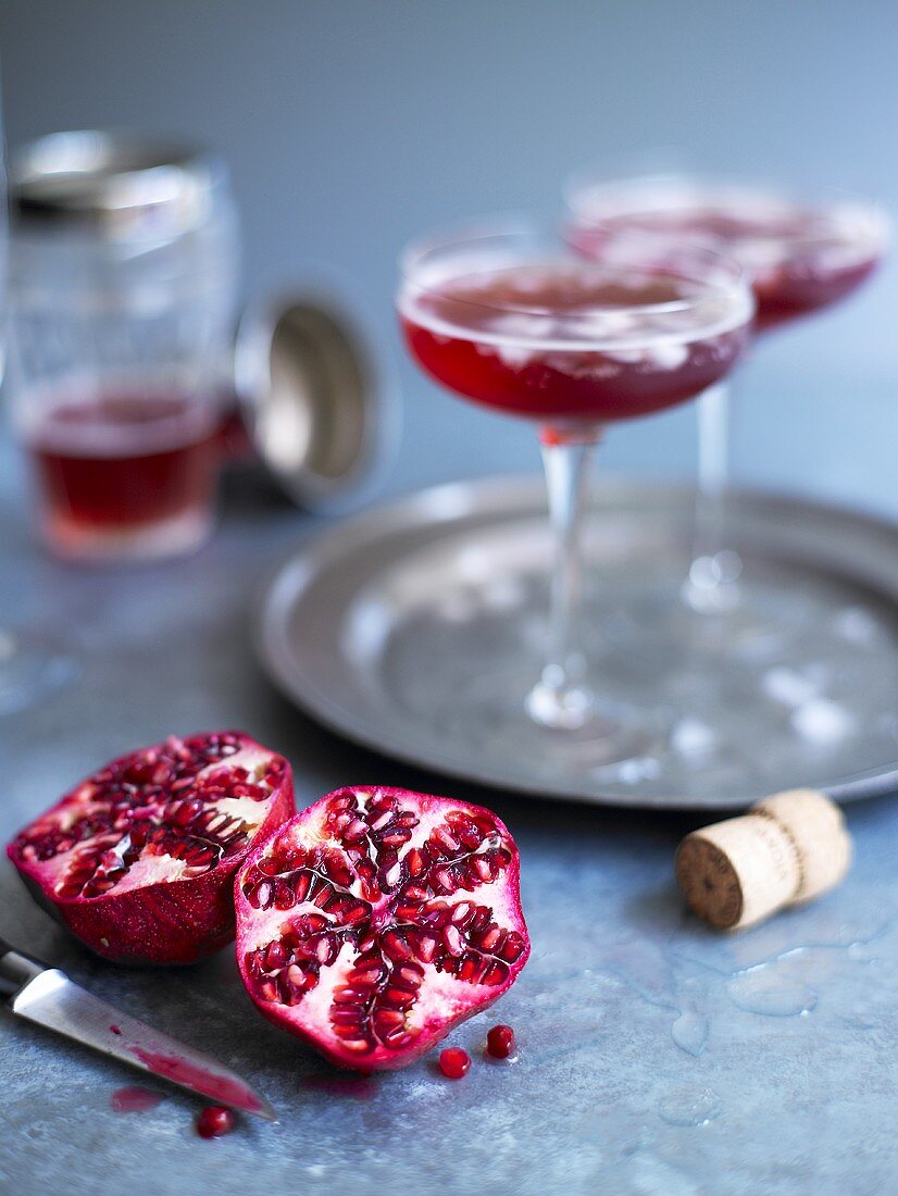 Pomegranate drinks and halved pomegranate