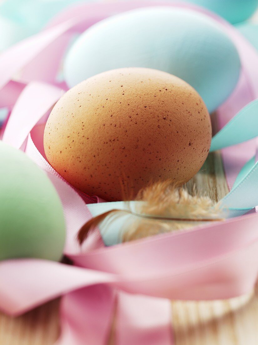 Hens' eggs among gift ribbons