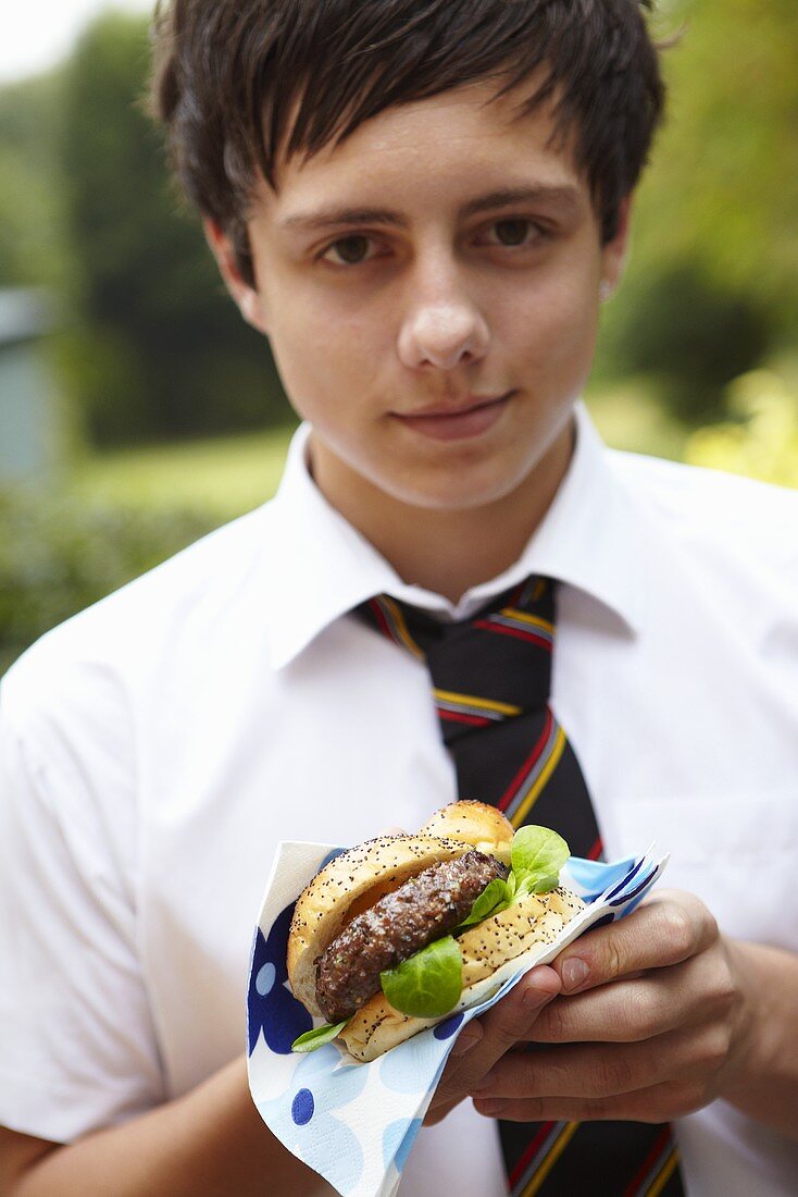 Schoolboy with hamburger