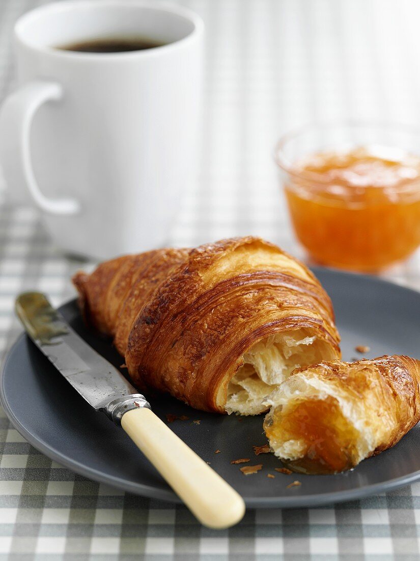 Croissant with marmalade and coffee