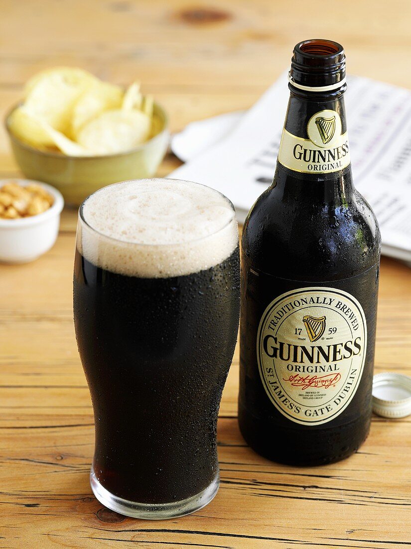 Glass of Guinness with bottle