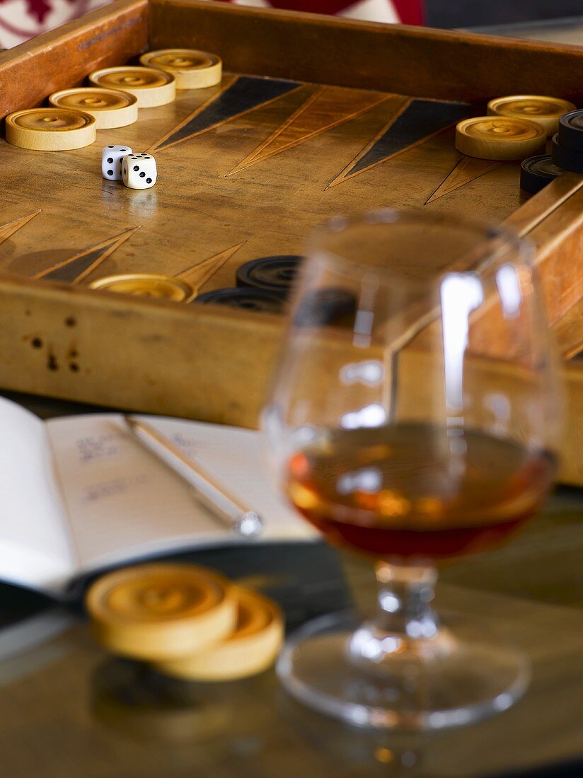 Glass of brandy in front of backgammon board