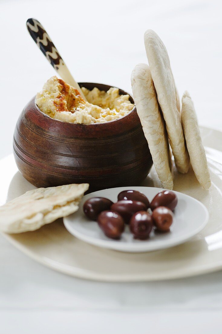 Hummus with pita bread and olives