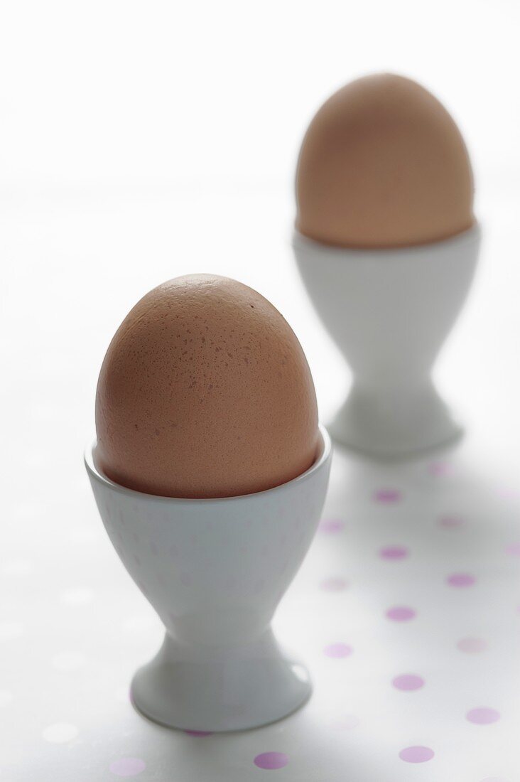 Two boiled eggs in egg cups