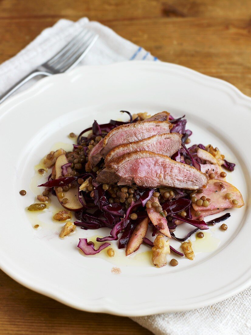 Duck breast on red cabbage salad with lentils, pear and walnuts