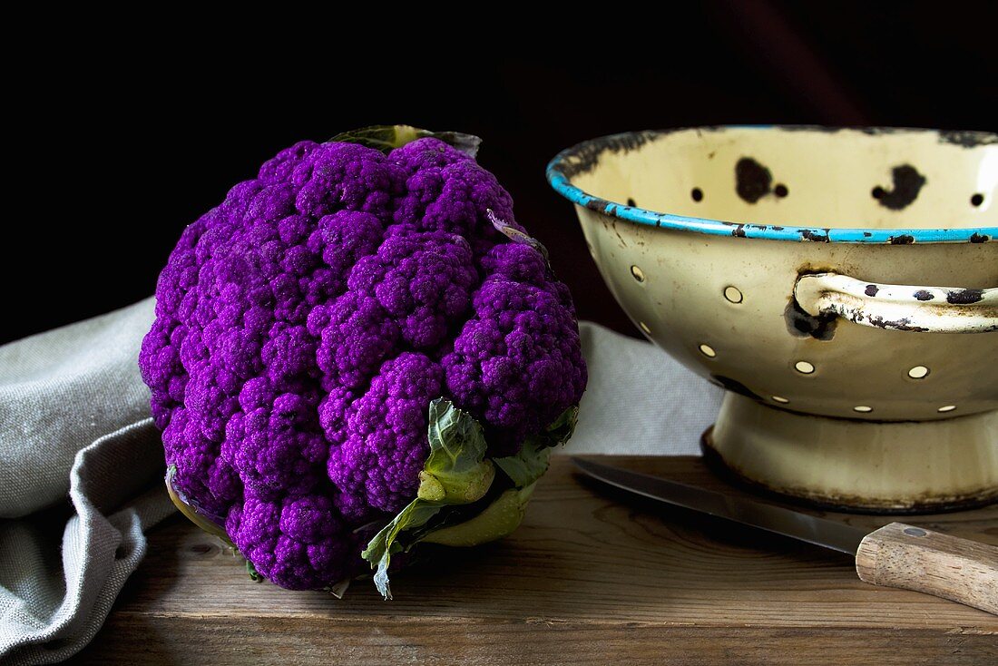 Purple cauliflower on wooden table