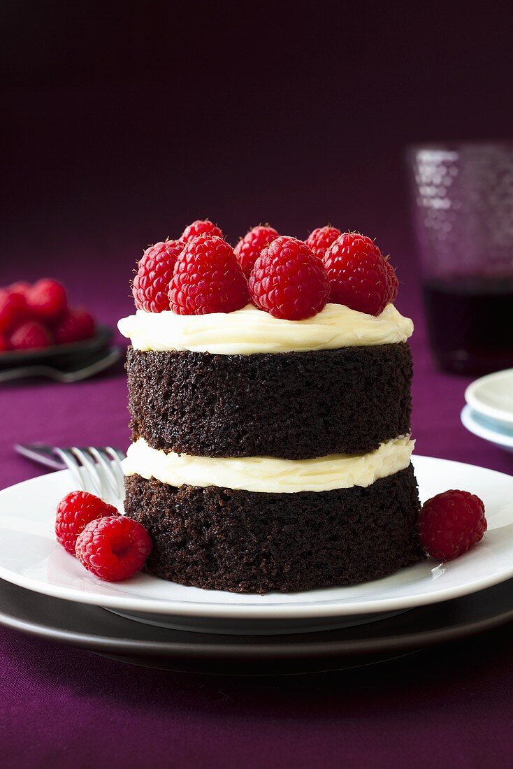 Small chocolate cake with buttercream and raspberries