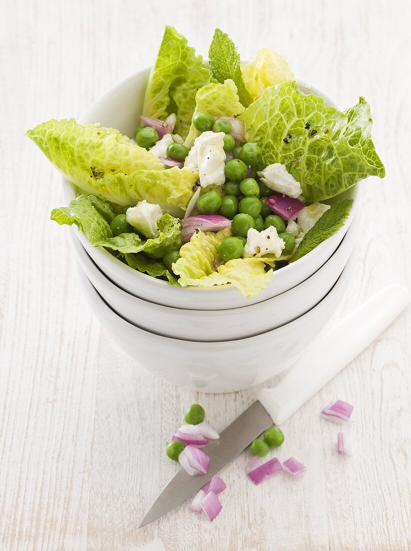 Romaine lettuce with peas, feta cheese and onions