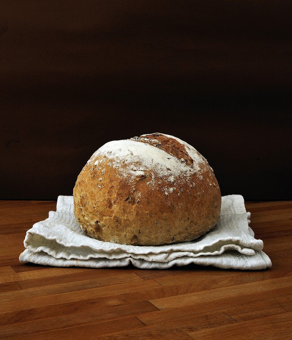 A loaf of bread on tea towel