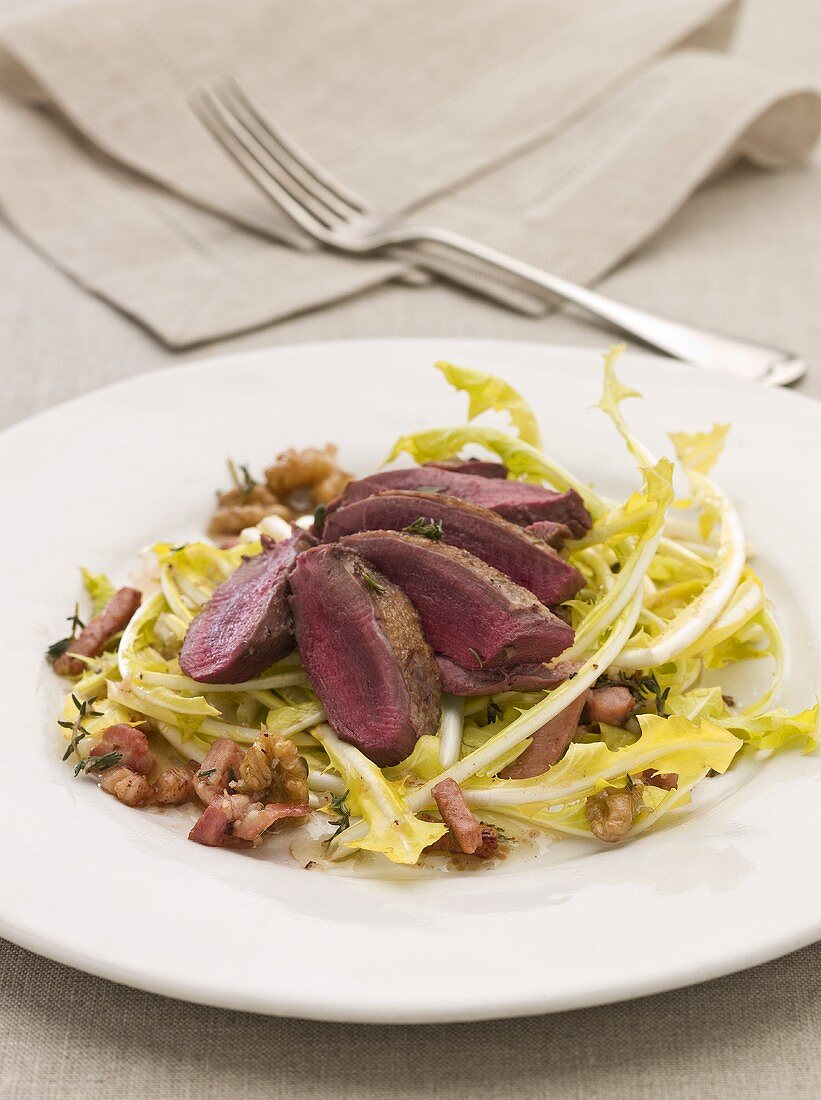 Endive salad with fillet of wild pigeon, bacon and walnuts