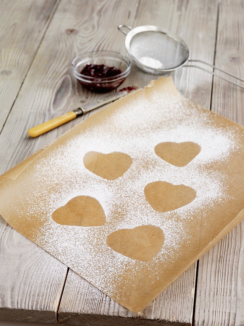 Outlines of heart-shaped biscuits in icing sugar