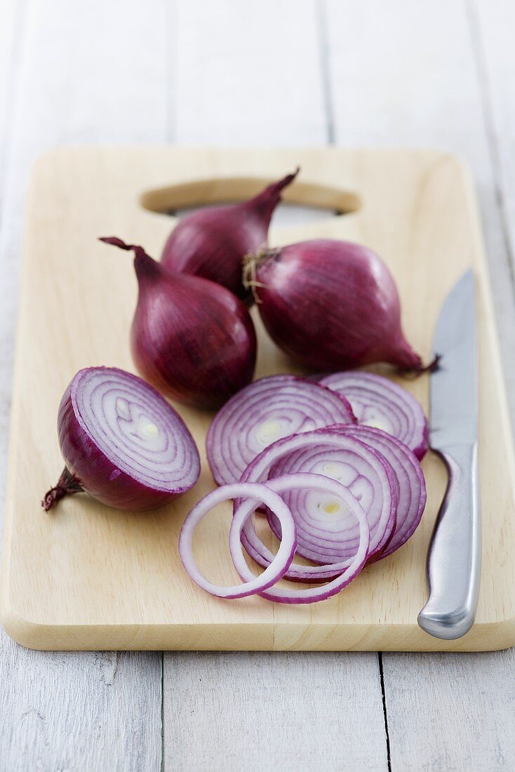 Red onions on chopping board