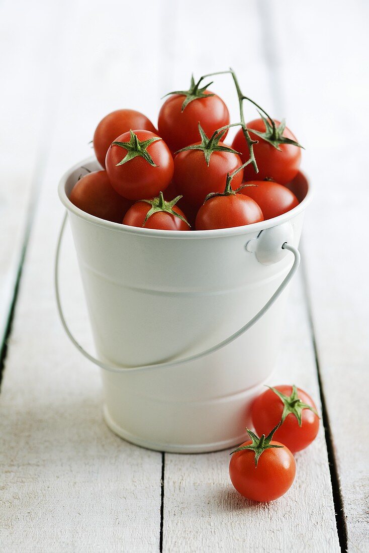 A bucket full of cherry tomatoes
