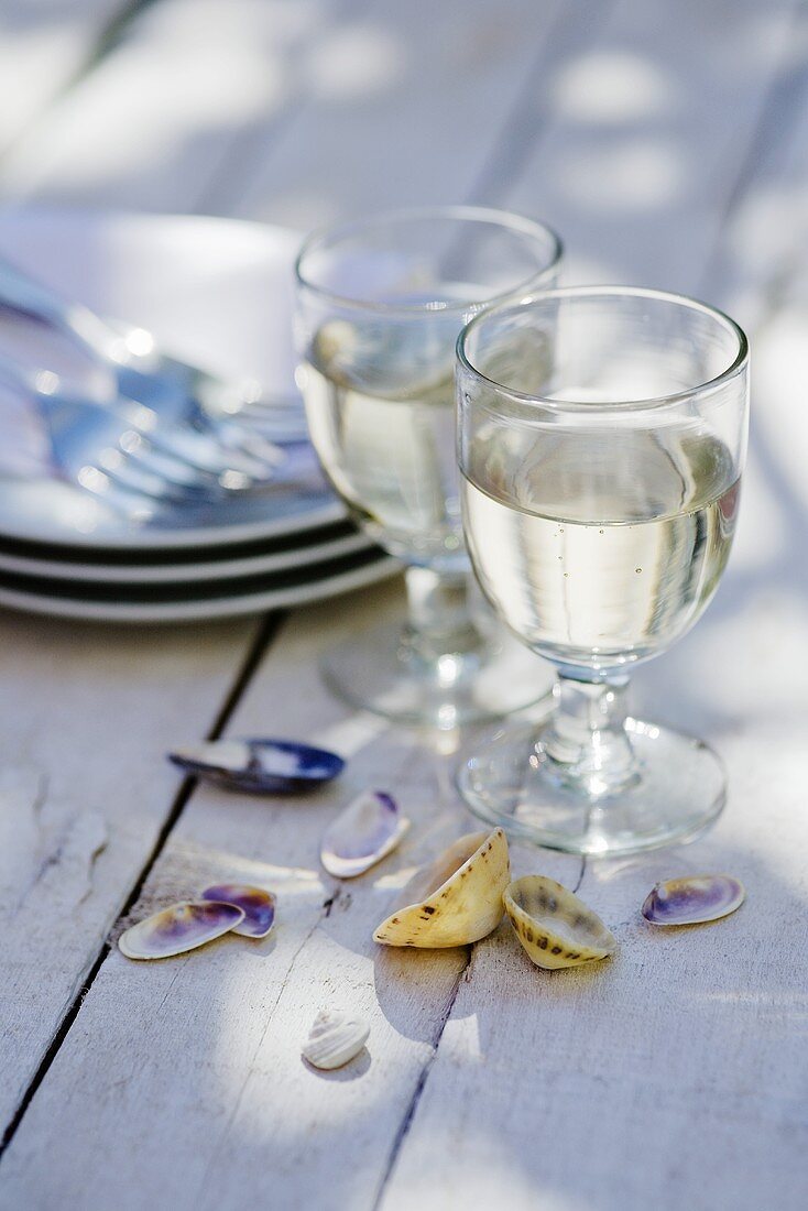 Two glasses of white wine on wooden table