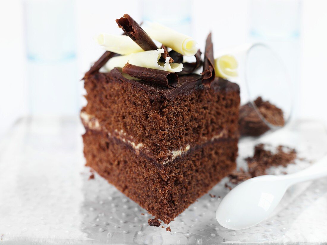Square of chocolate cake with chocolate curls