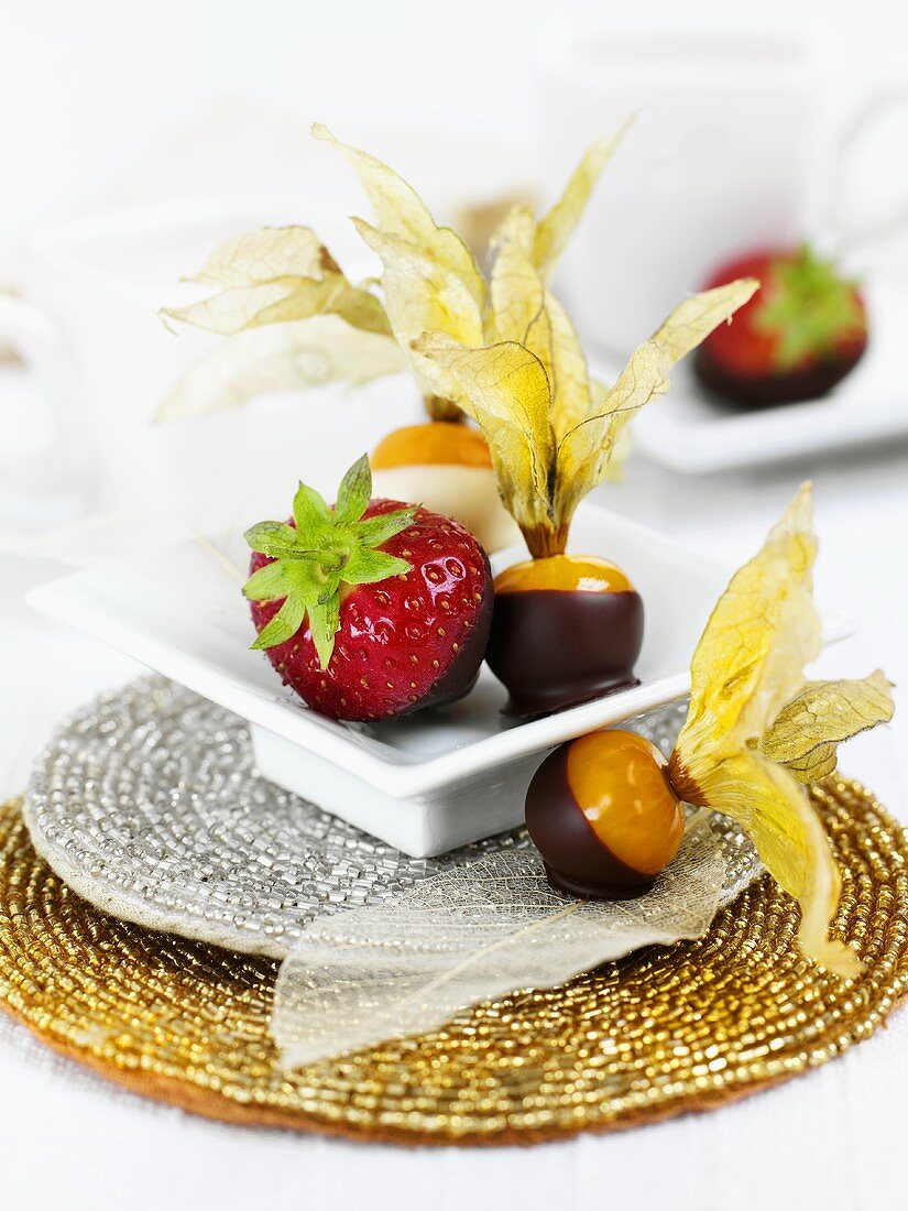 Chocolate-dipped strawberries and physalis