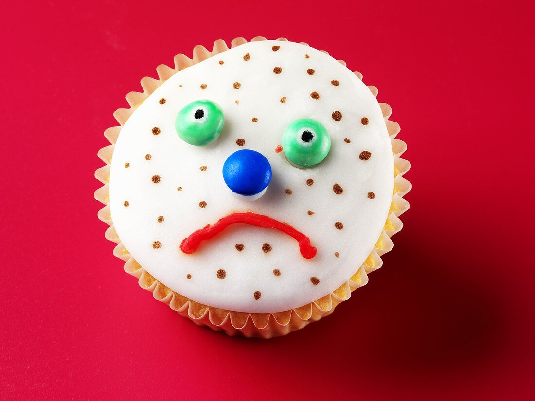 Cupcake mit traurigem Gesicht