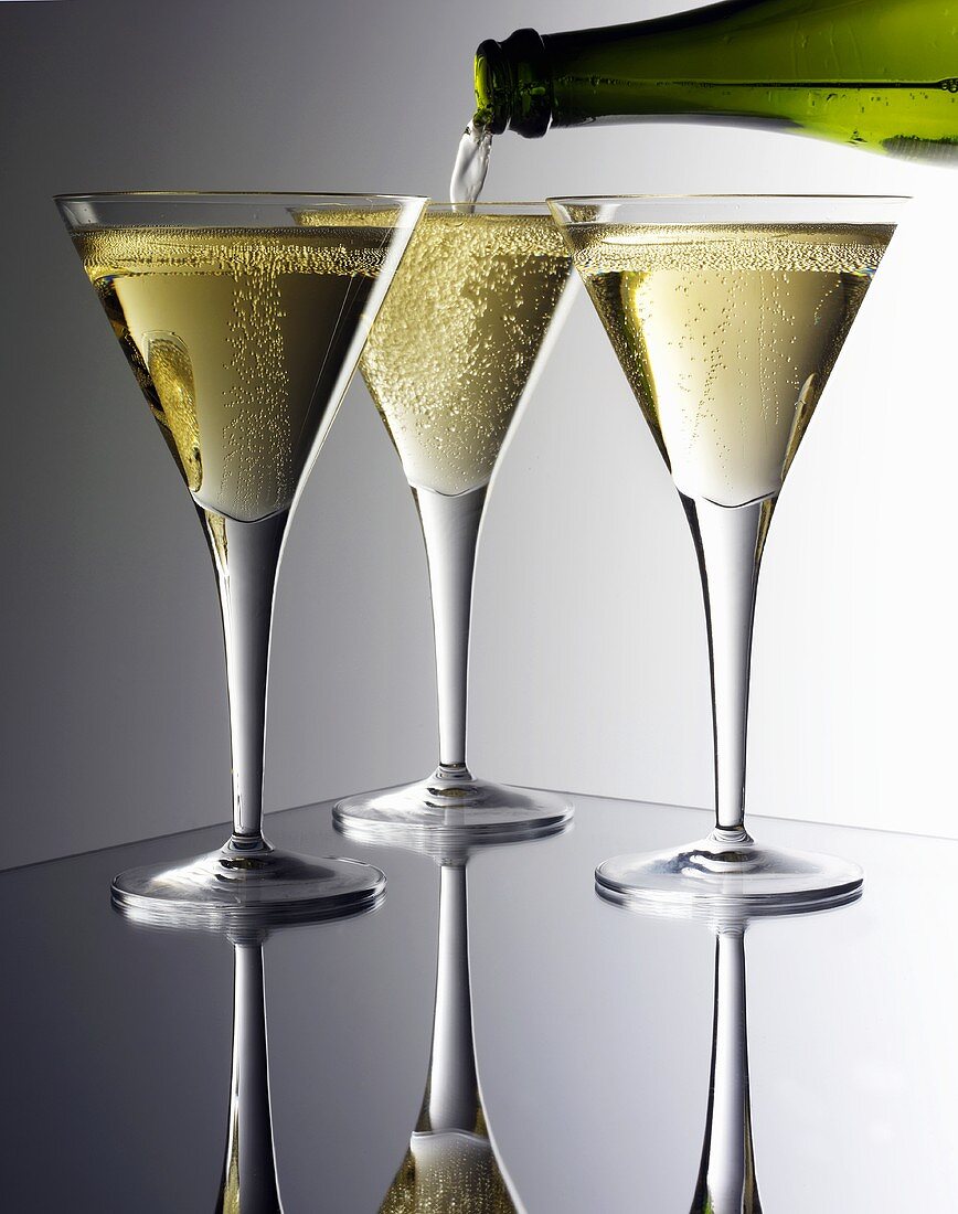 Pouring sparkling wine into glasses