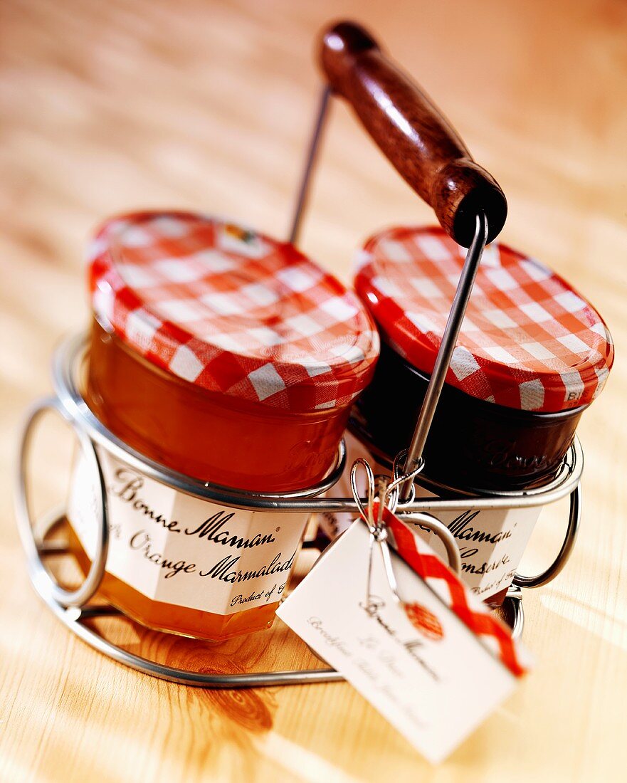 Two jars of French jam in a carrying basket