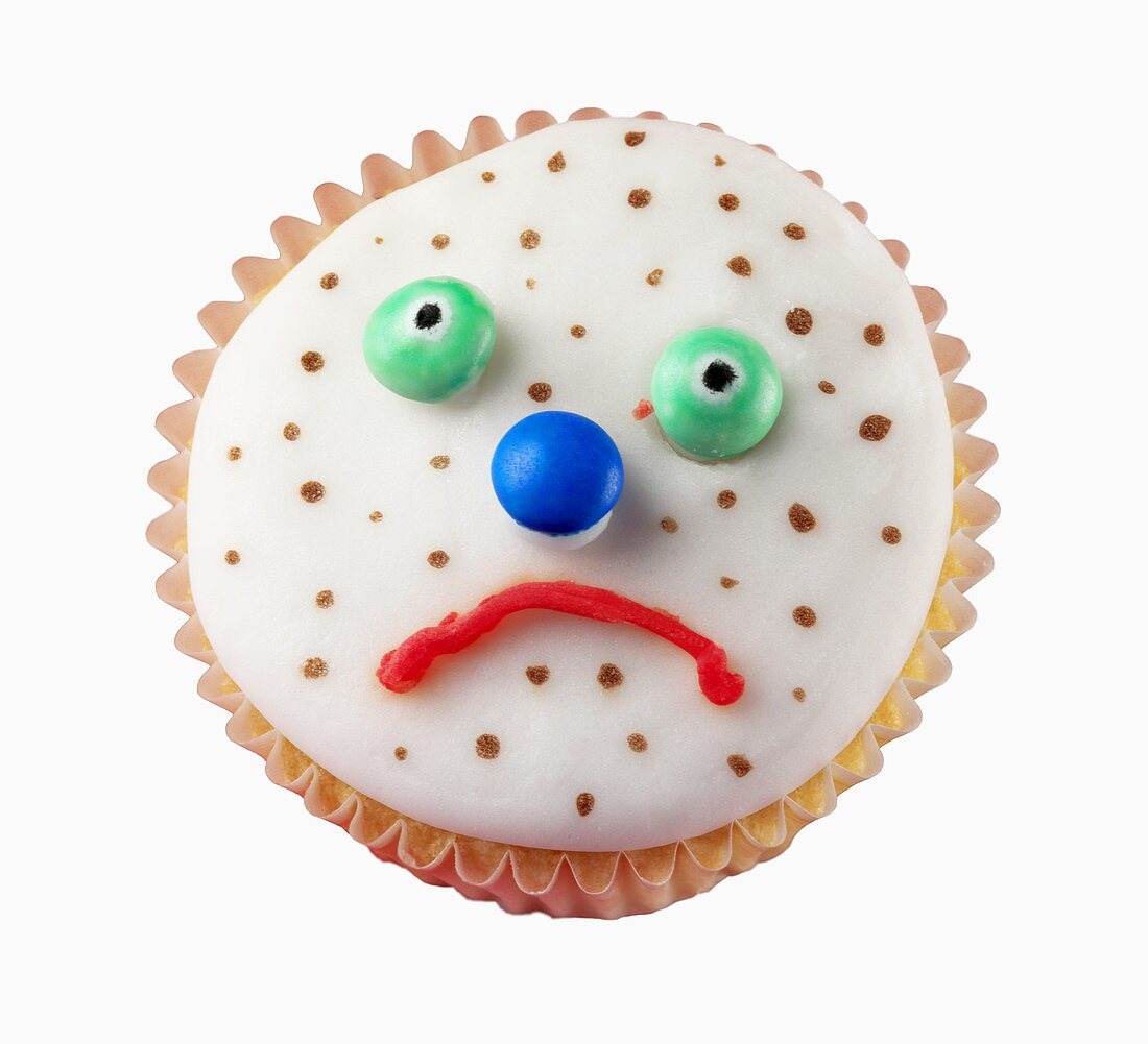 Fairy cake with a sad, spotty face