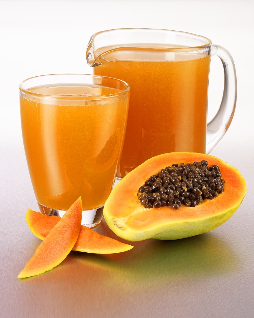 Papaya juice in a glass and in a glass jug