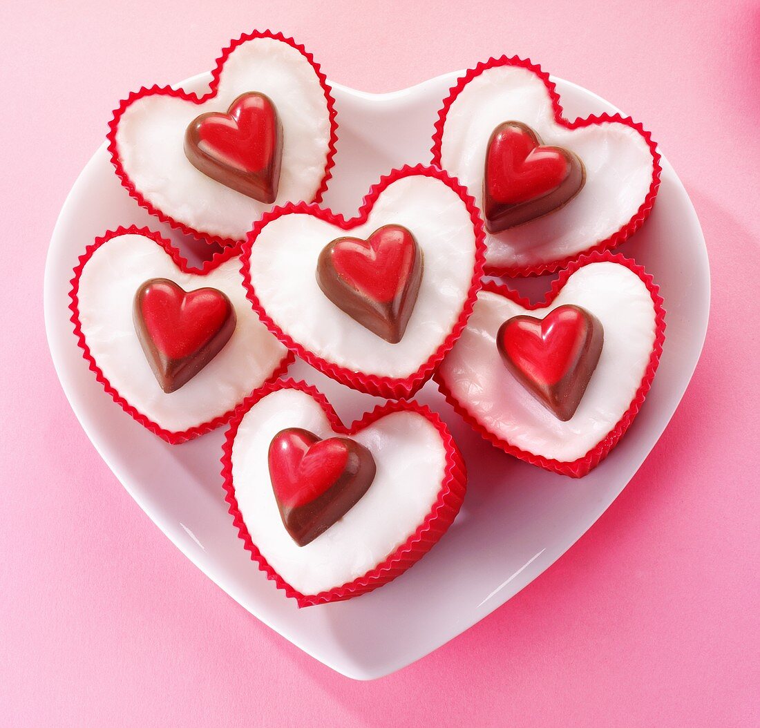 Heart-shaped fairy cakes decorated with heart-shaped pralines