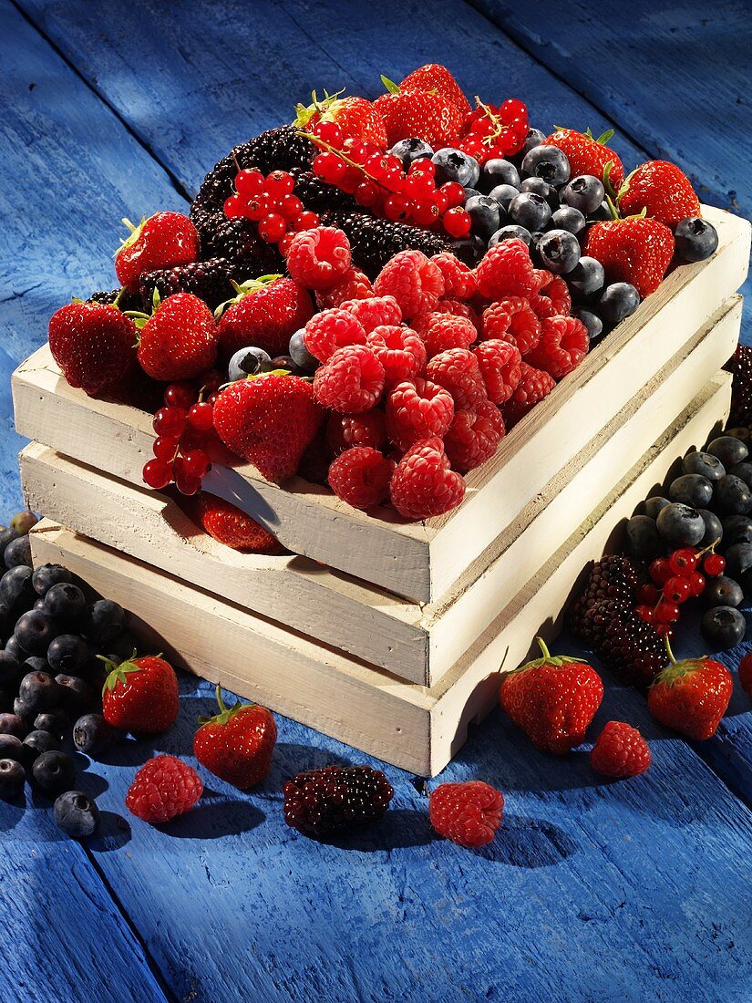 A wooden basket of fresh berries