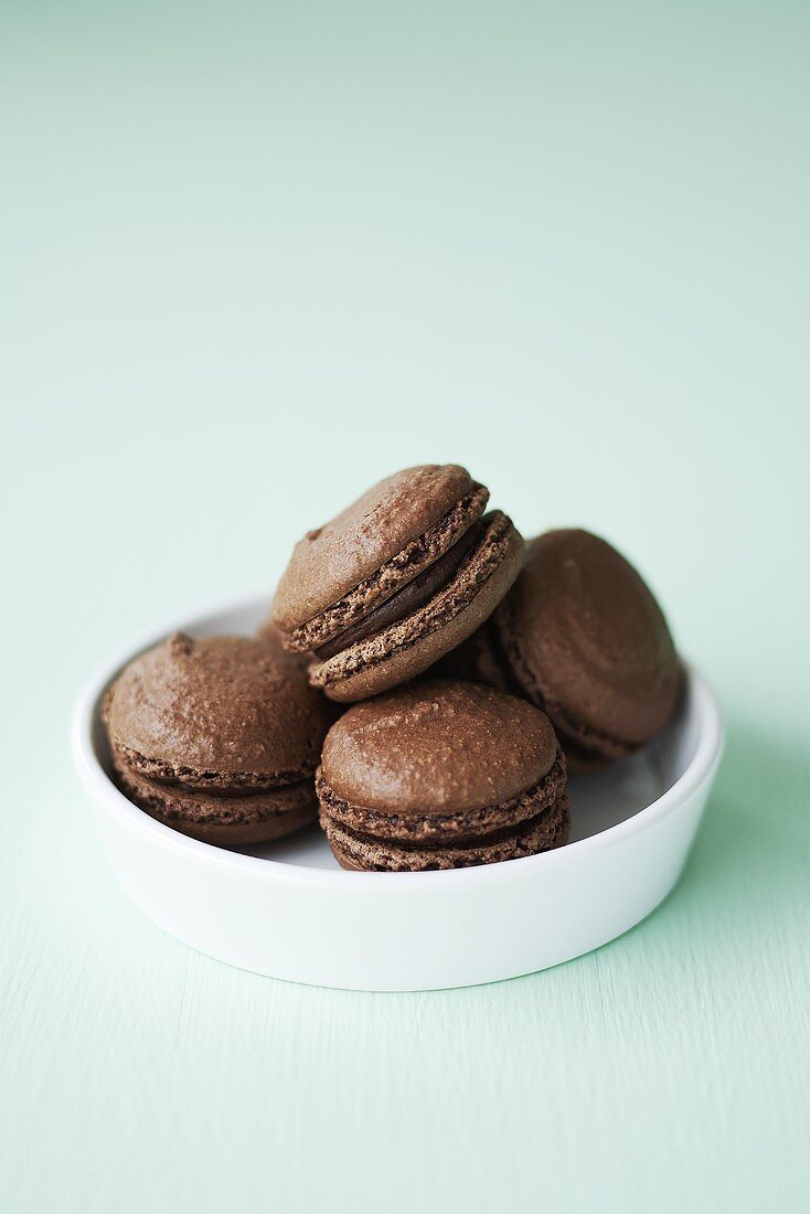 A bowl of chocolate macarons