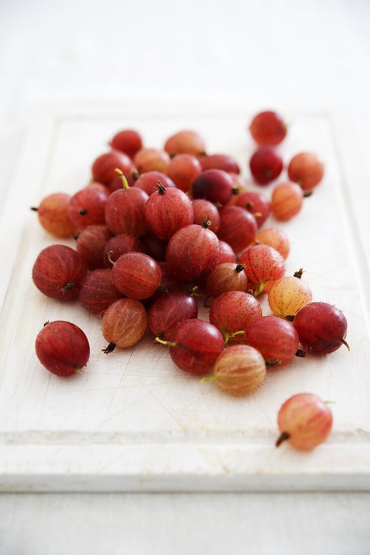 A pile of gooseberries on a chopping board