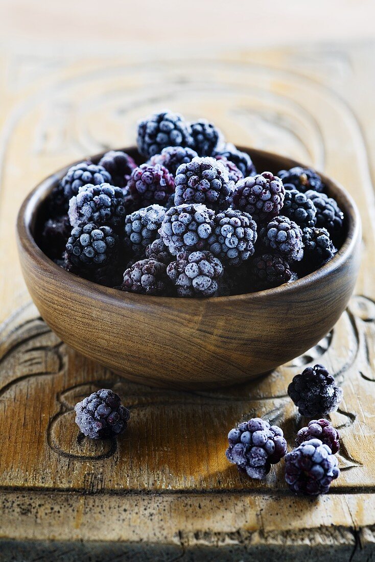 Frozen blackberries in a wooden bowl