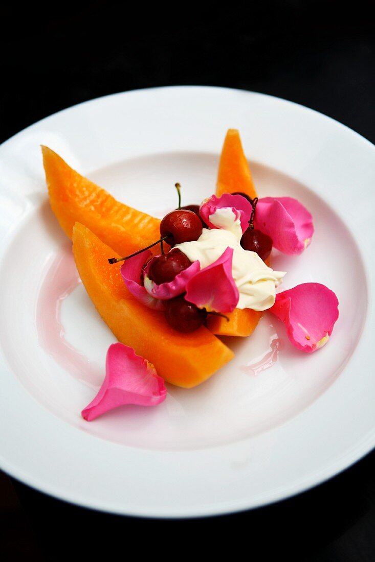 Honeydew melon with cherries, creme fraiche and rose petals