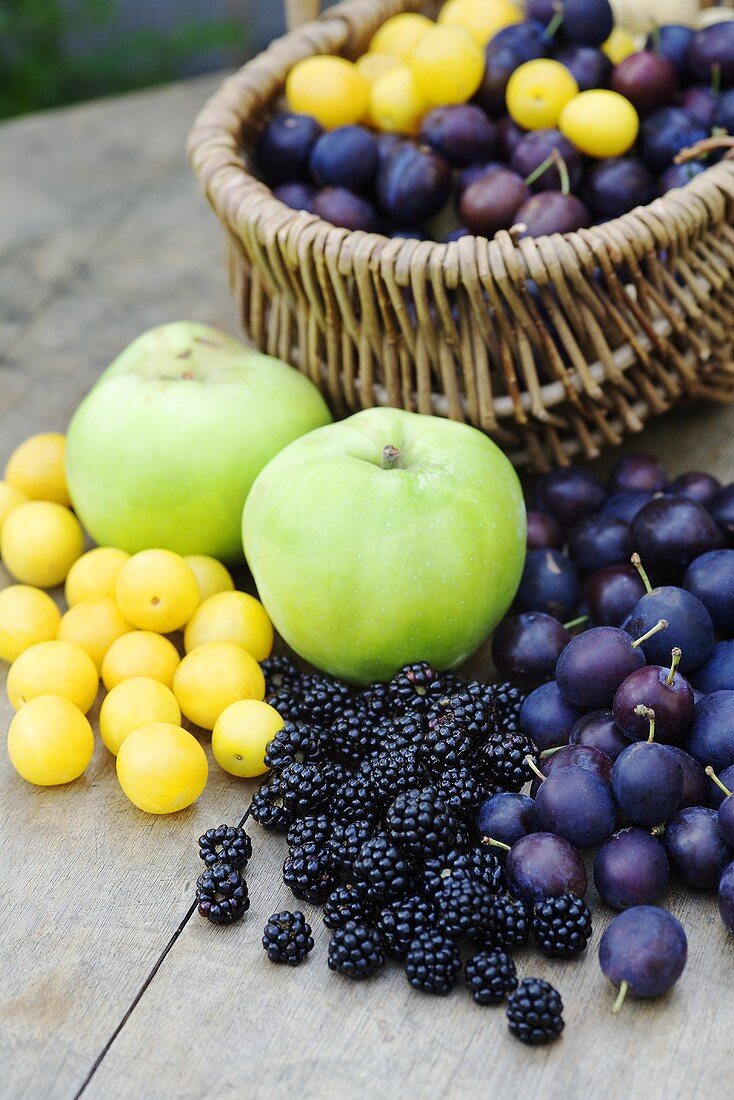 Various types of fruits, some in a basket
