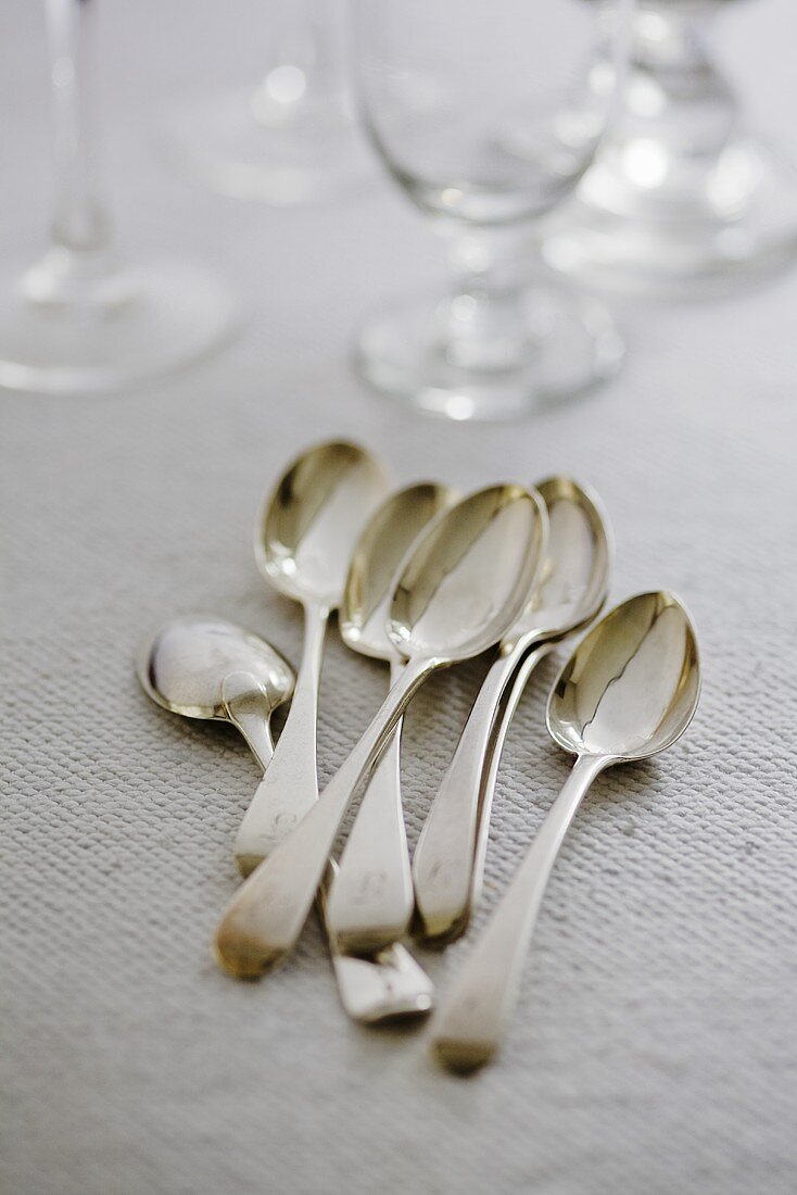 Antique silver spoons and glasses