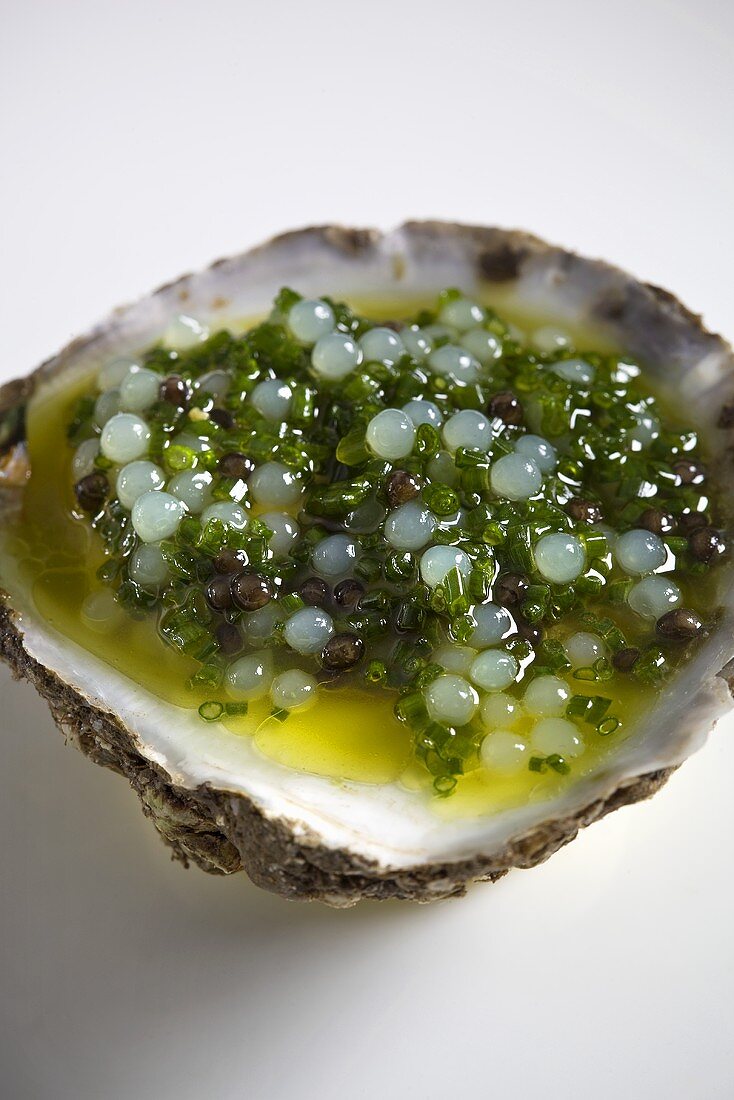 A raw oyster with a caviar vinaigrette