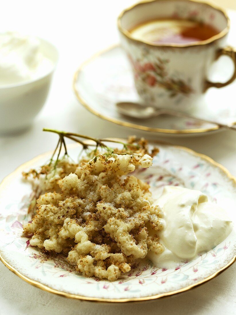 Baked elderflowers with cream and a cup of tea