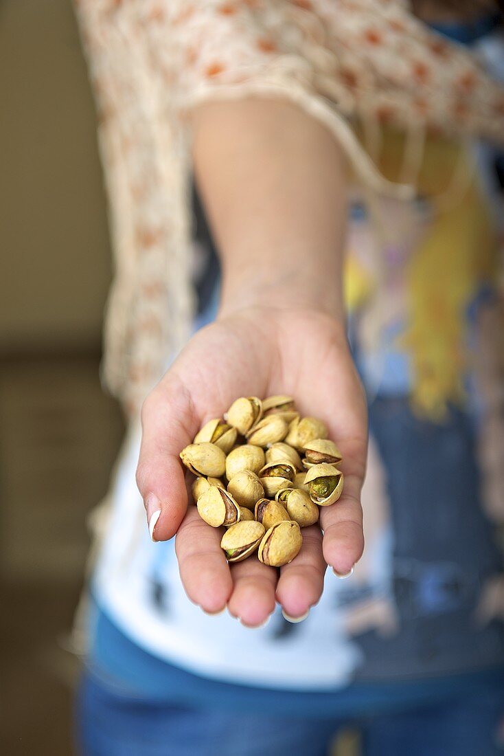 Pistachios in a woman's hand