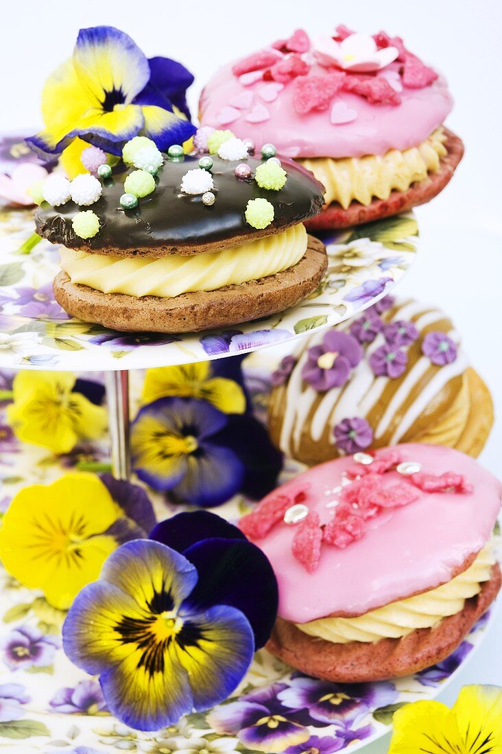 Verschiedene Whoopie Pies auf Etagere mit Stiefmütterchen