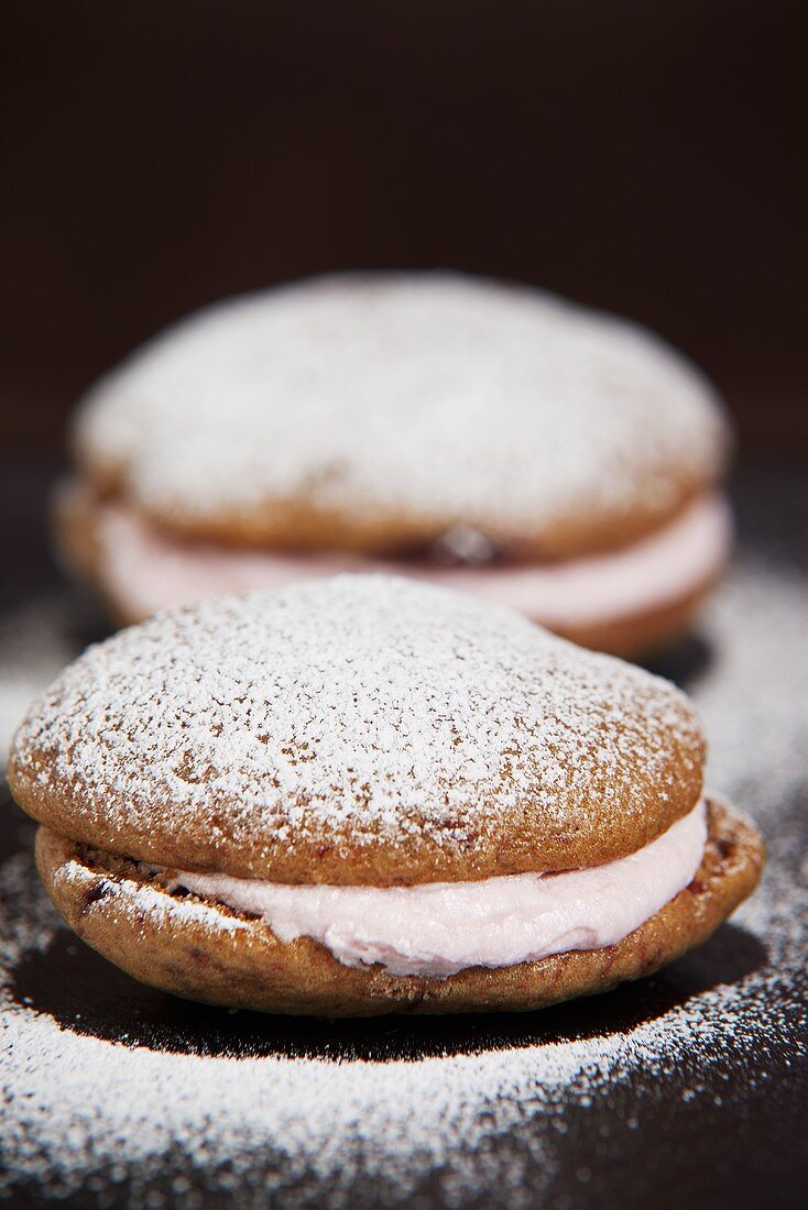 Two whoopie pies with icing sugar
