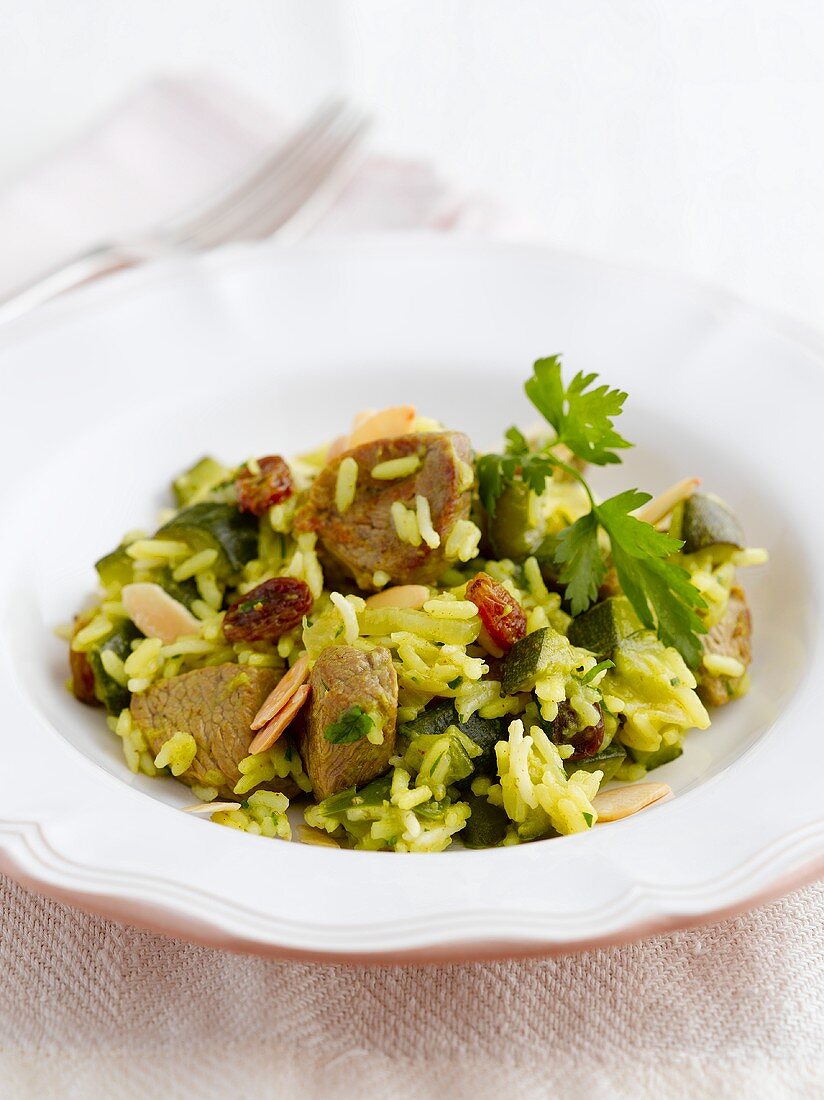 Rice with pork, courgette, almonds and raisins
