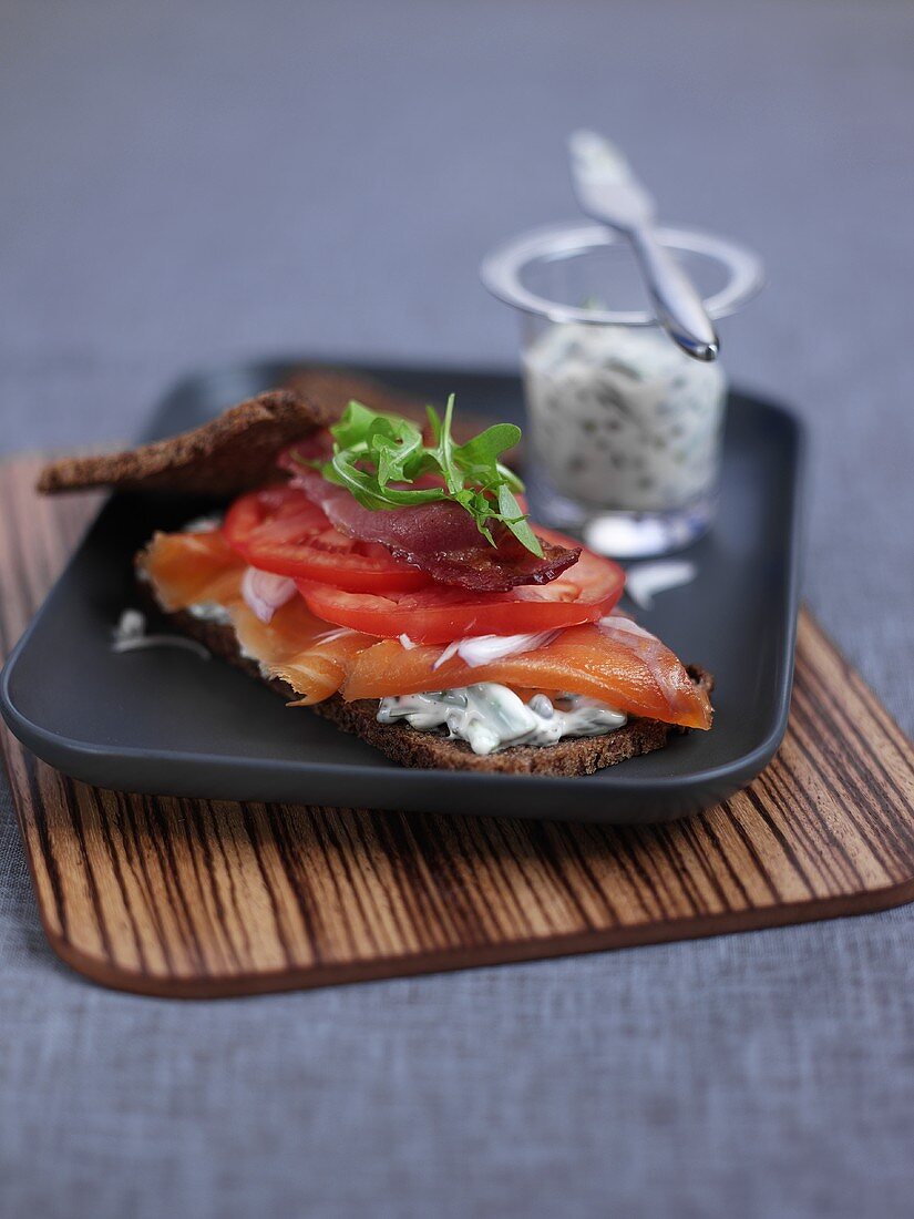 Smoked salmon with cream cheese and tomatoes on rye bread