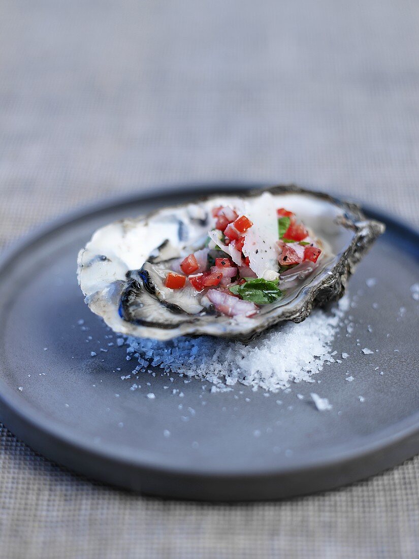 Oyster bruschetta with diced tomatoes and parmesan