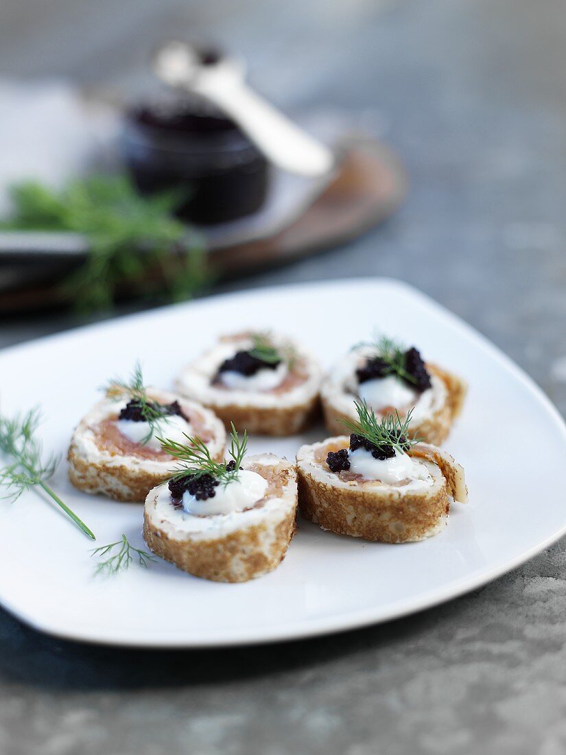 Räucherlachs-Frischkäse-Röllchen mit Kaviar und Dill