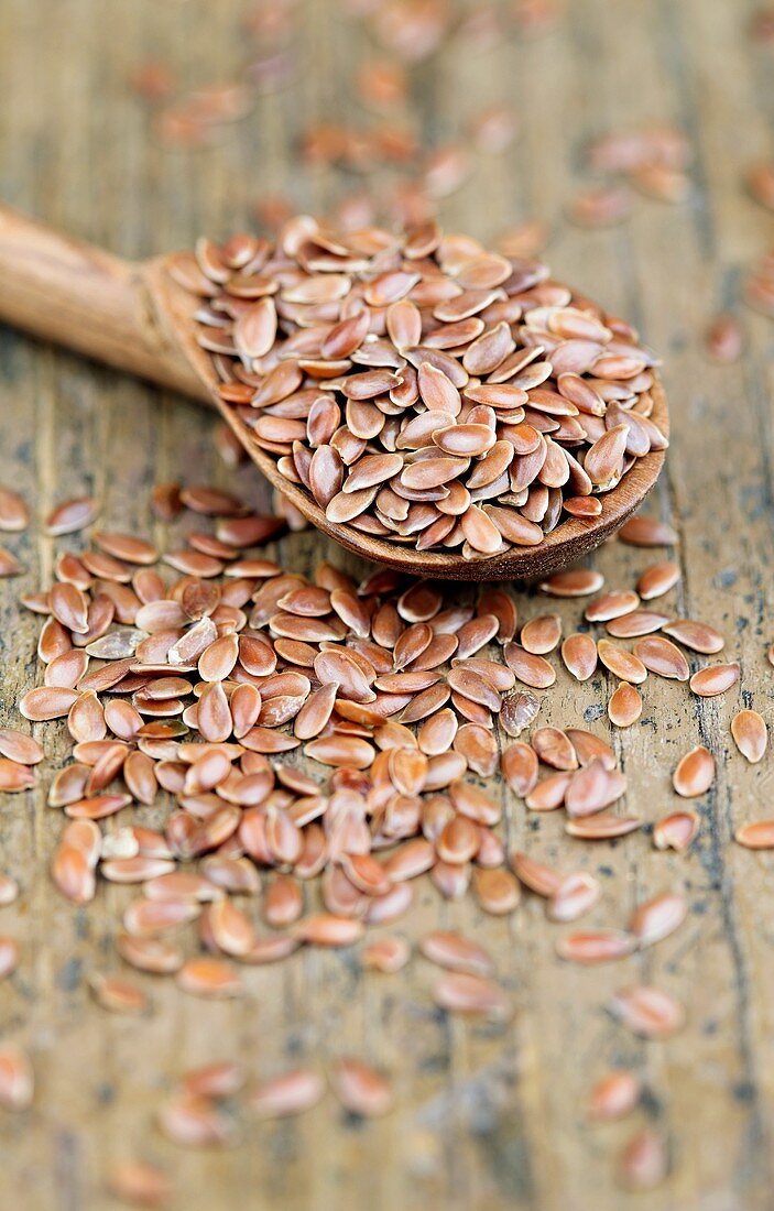 Flaxseeds with a wooden spoon